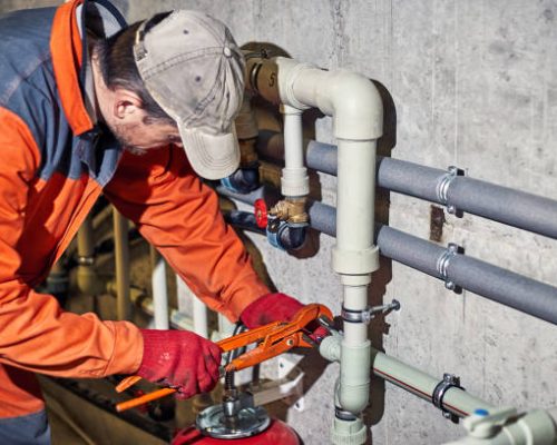 Plumber worker repairs the heating system in the house. Plumber worker repairs the heating system in the house.